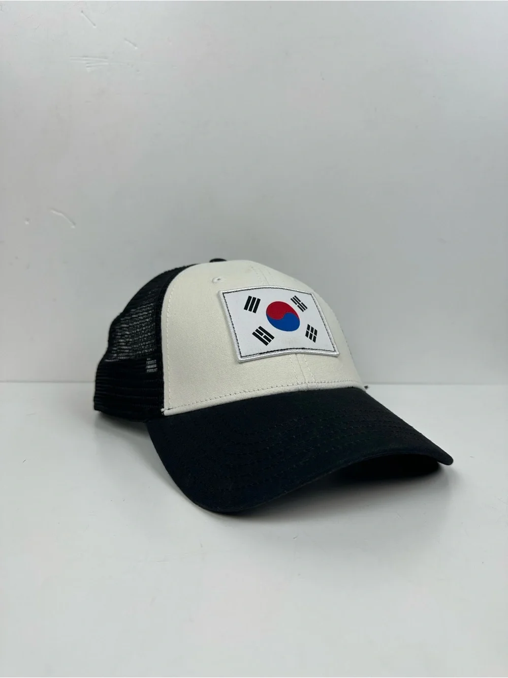 The North Face Black & White Trucker Hat with South Korea Flag Patch